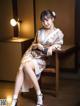 A woman in a kimono sitting on a wooden table.