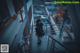 A person standing on a stairway in an industrial area.