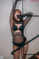 A woman in a black lingerie posing on a staircase.