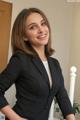 A woman in a black suit posing for a picture.