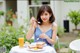 A woman sitting at a table with a plate of food.