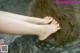 A woman's bare feet in a body of water.