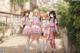 A group of girls in school uniforms walking down a street.