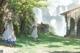 A couple of women standing next to each other near a waterfall.