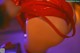 A woman in a red bikini with a red ribbon around her waist.